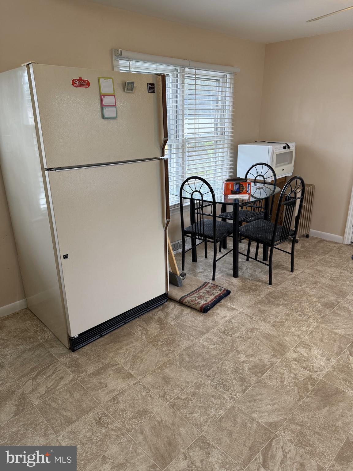 4870 Calvert Drive St. Leonard, MD 20685 - Photo 5 of 10 a white refrigerator freezer sitting next to a blue wall