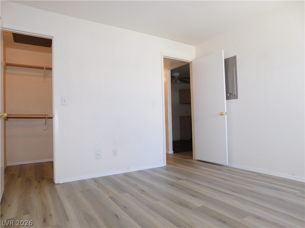 5221 South Lindell Road, Unit 202 Las Vegas, NV 89118 - Photo 21 of 28 Newly installed hardwood flooring extends through this inviting bedroom, featuring a convenient walk-in closet.