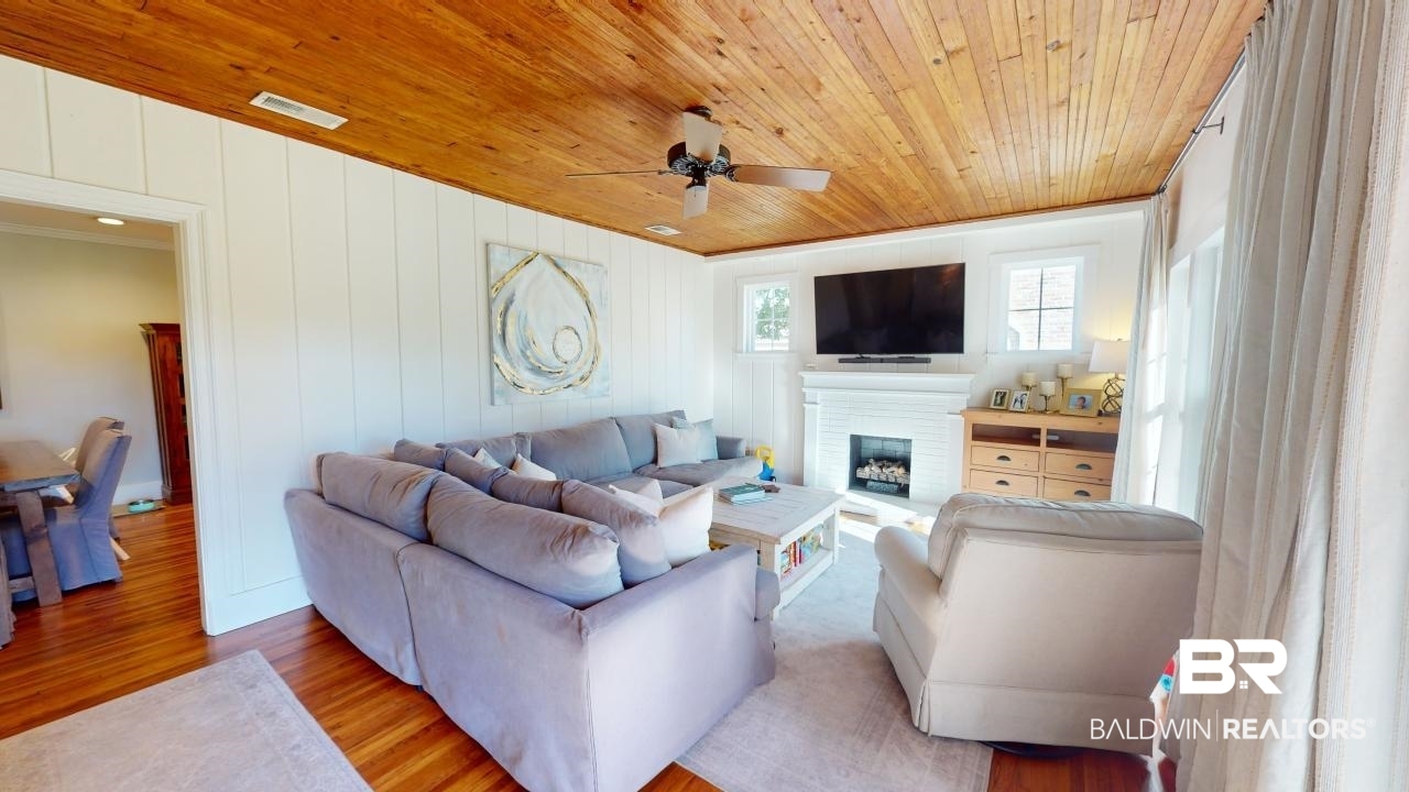 4358 Stein Street Mobile, AL 36608 - Photo 3 of 29 Living room with ceiling fan, wooden ceiling, a brick fireplace, crown molding, and light wood-type flooring