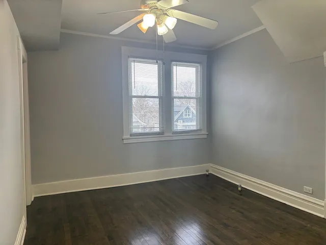 a view of wooden floor and windows in a room
