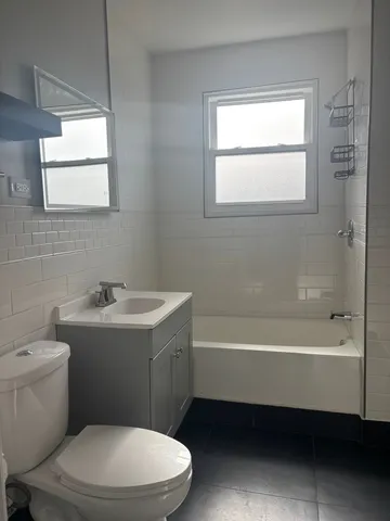 a bathroom with a sink a toilet and bathtub