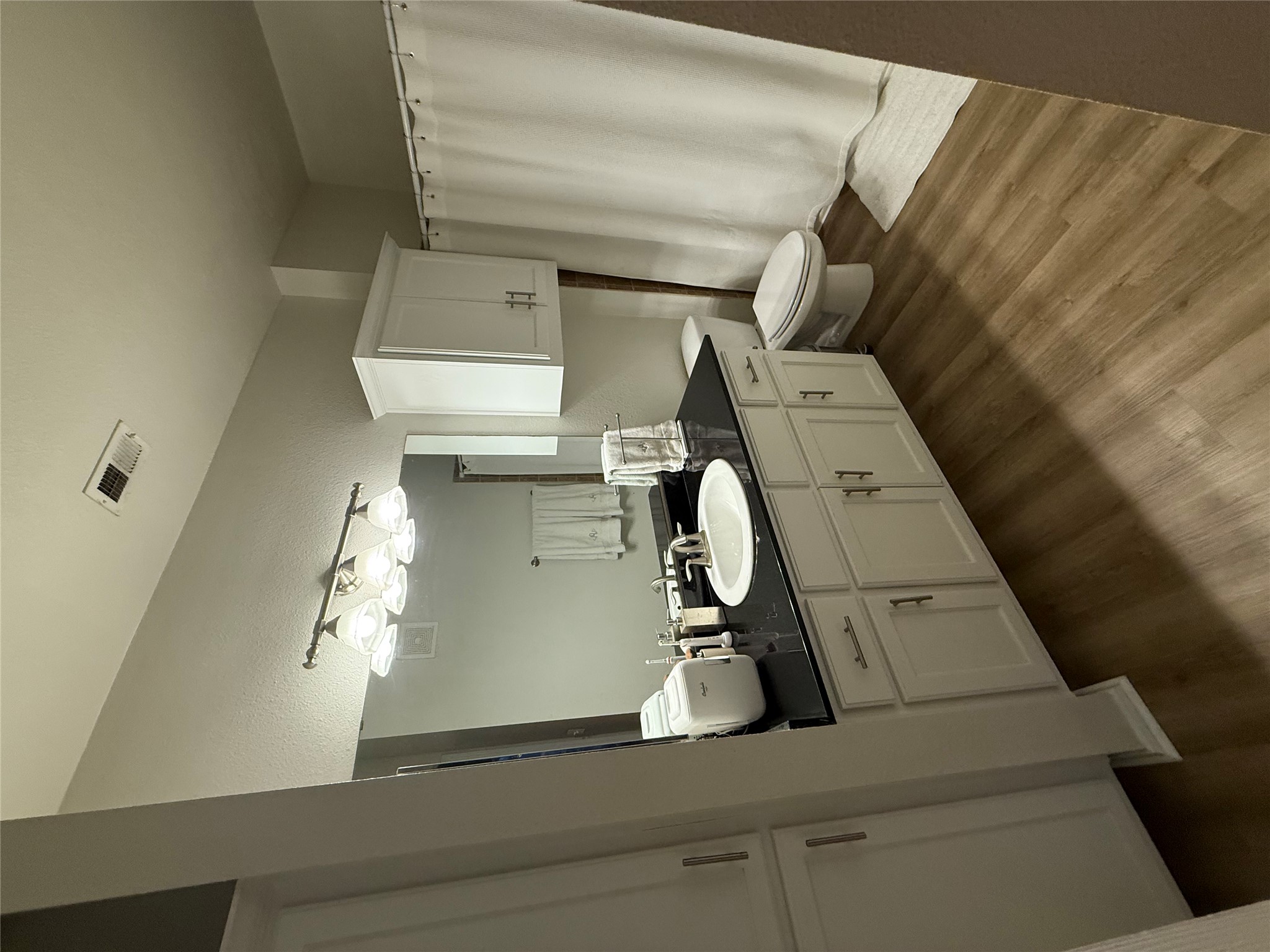 910 West 25th Street, Unit 508 Austin, TX 78705 - Photo 11 of 14 a bathroom with a double vanity sink and mirror