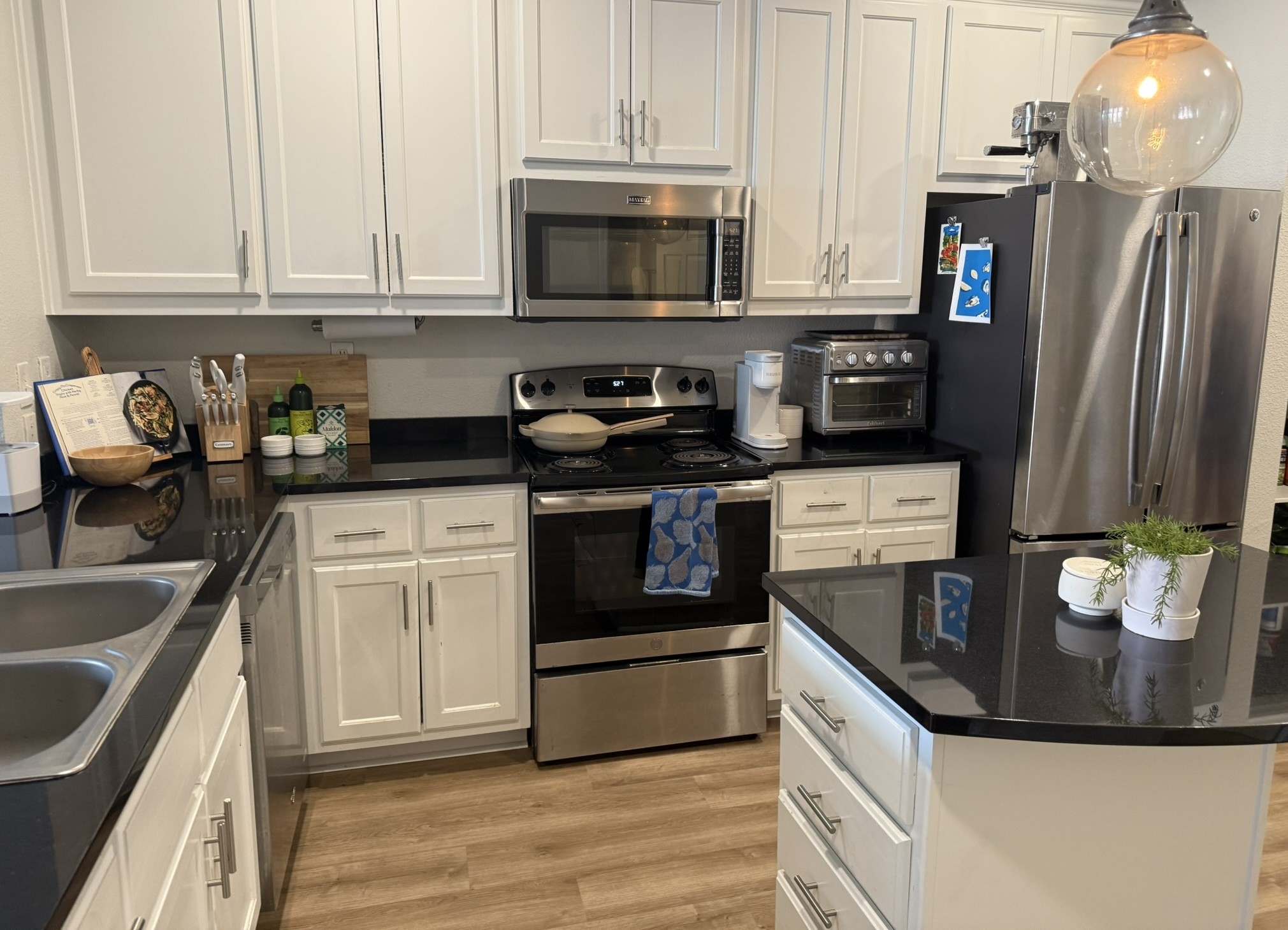 910 West 25th Street, Unit 508 Austin, TX 78705 - Photo 3 of 14 a kitchen with stainless steel appliances granite countertop a stove a sink and a microwave