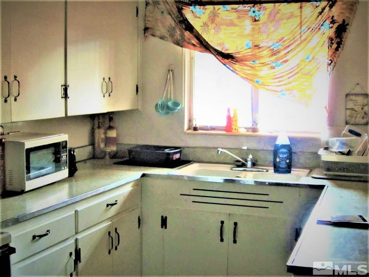 44 West 10th Street Reno, NV 89503 - Photo 23 of 27 a kitchen with a sink stove and cabinets