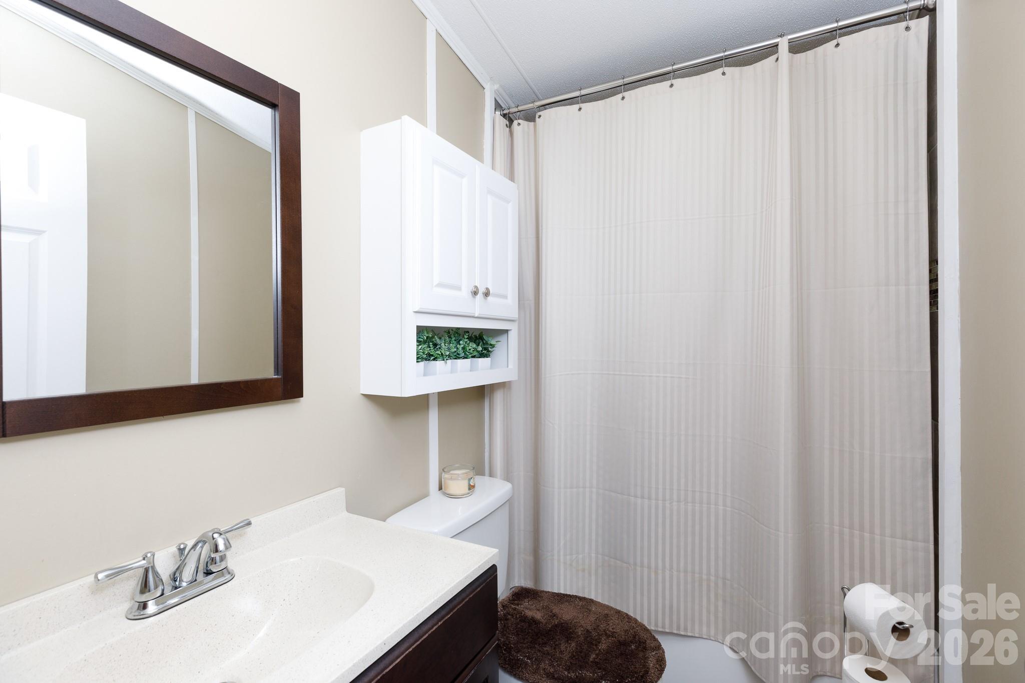 652 Sutton Spring Road York, SC 29745 - Photo 15 of 28 a bathroom with a sink and a mirror