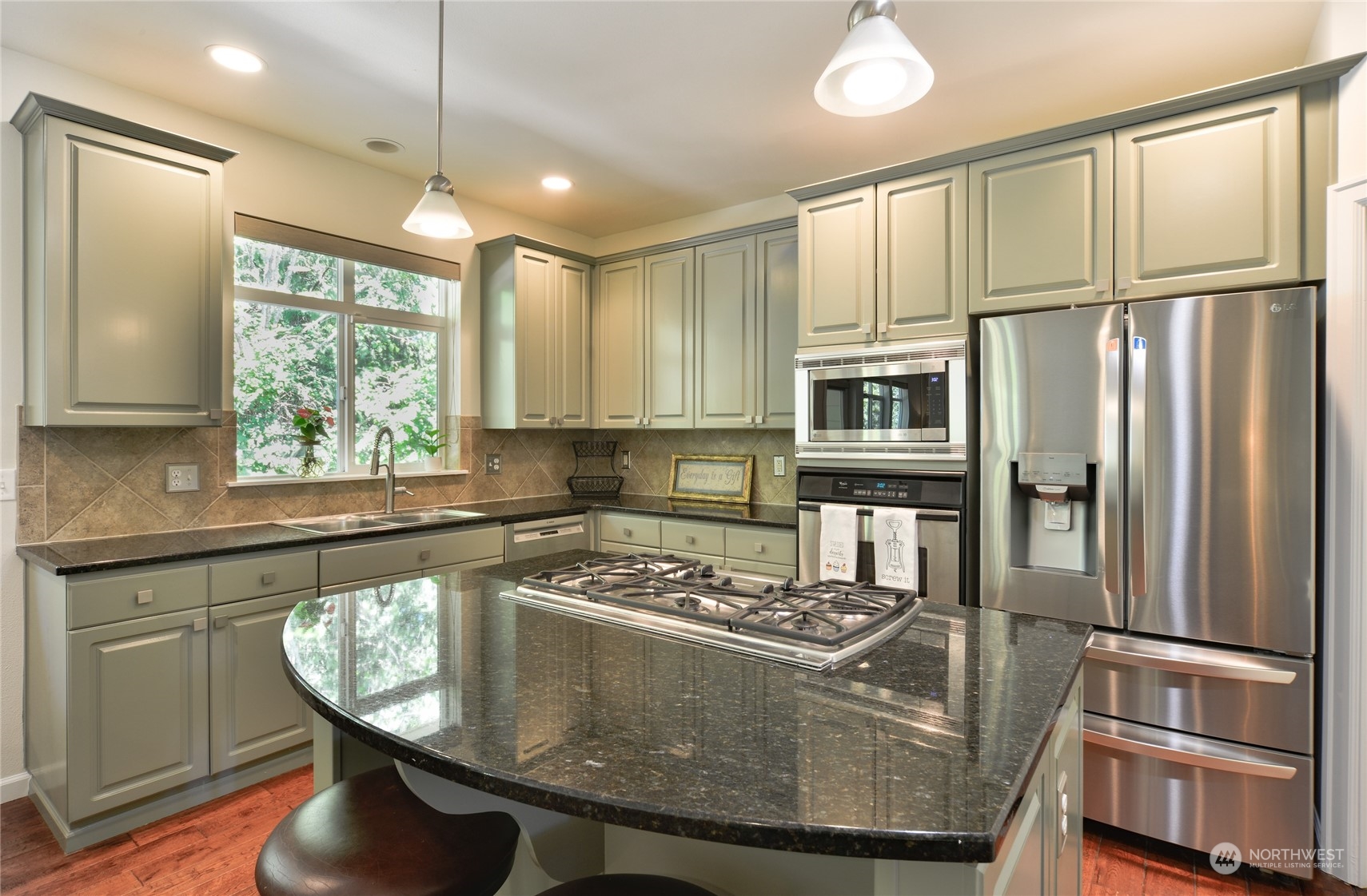 16520 Southeast 165th Way Renton, WA 98058 - Photo 11 of 35 a kitchen with stainless steel appliances granite countertop a stove a refrigerator and a sink