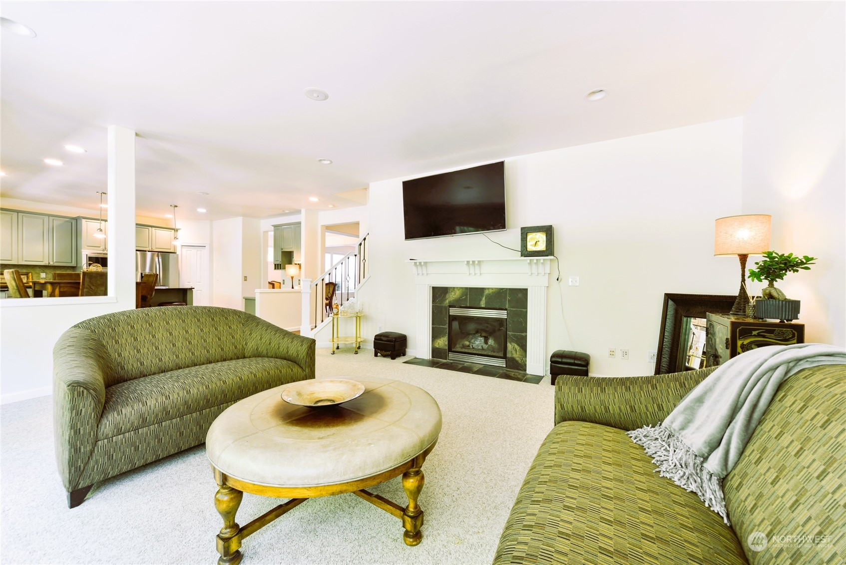 16520 Southeast 165th Way Renton, WA 98058 - Photo 16 of 35 a living room with furniture a flat screen tv and a fireplace