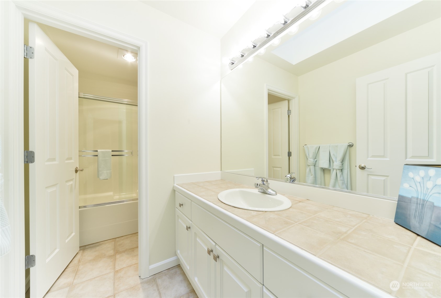16520 Southeast 165th Way Renton, WA 98058 - Photo 31 of 35 a bathroom with a granite countertop sink and a mirror