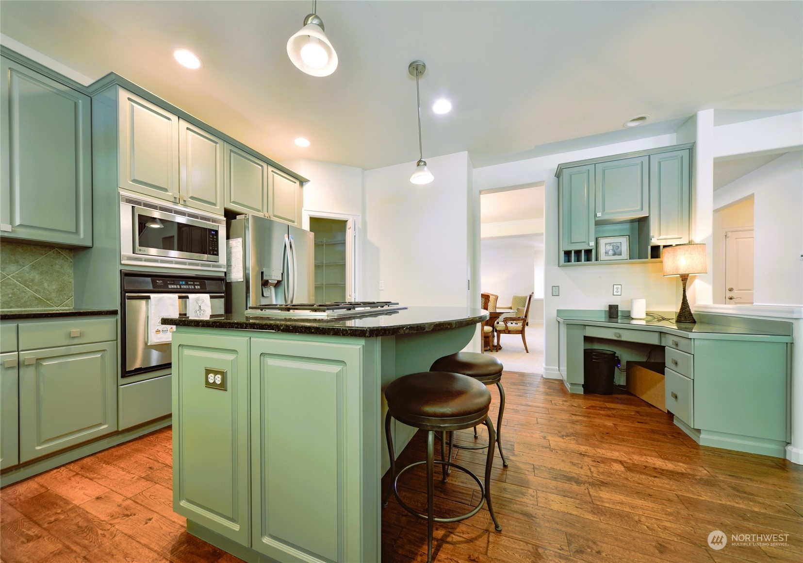 16520 Southeast 165th Way Renton, WA 98058 - Photo 10 of 35 a kitchen with stainless steel appliances granite countertop a sink a stove a refrigerator cabinets and chairs