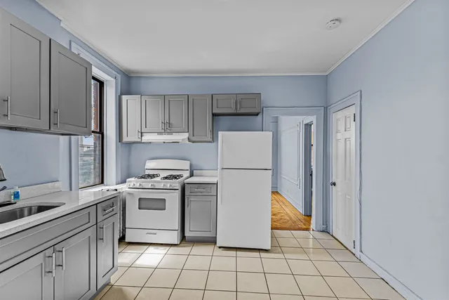 a kitchen with a stove a refrigerator and a sink