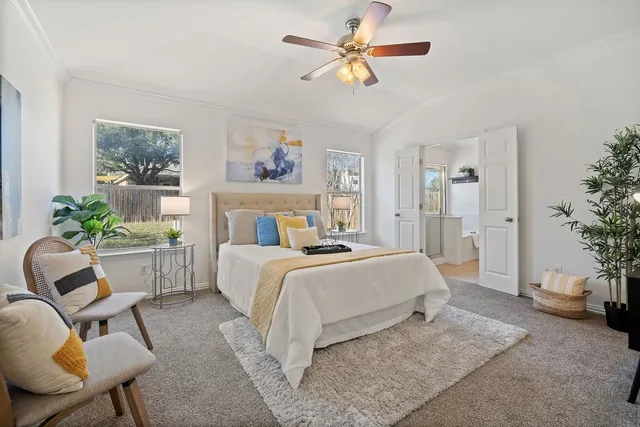 a bathroom with a granite countertop sink and a window