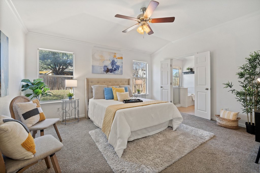 218 Calline Mayes Run Buda, TX 78610 - Photo 13 of 27 a bedroom with a bed a couch and potted plant on the dresser