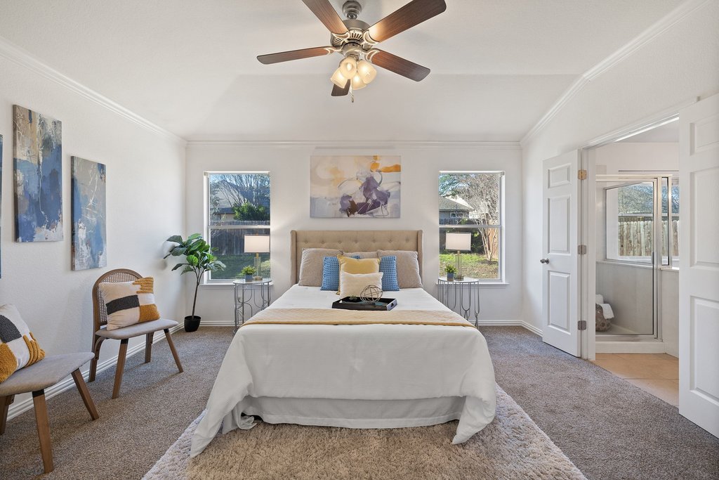 218 Calline Mayes Run Buda, TX 78610 - Photo 15 of 27 a bedroom with a bed and a table