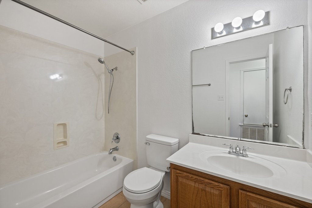 218 Calline Mayes Run Buda, TX 78610 - Photo 20 of 27 a bathroom with a sink a toilet and shower