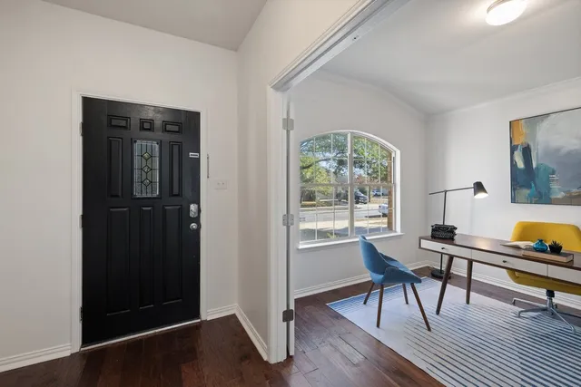 a workspace with wooden floor and a window