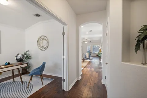a view of a room with furniture wooden floor and windows