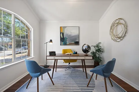 a kitchen with a stove a sink a microwave a dining table and chairs