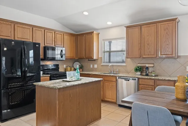 a large kitchen with a table and chairs
