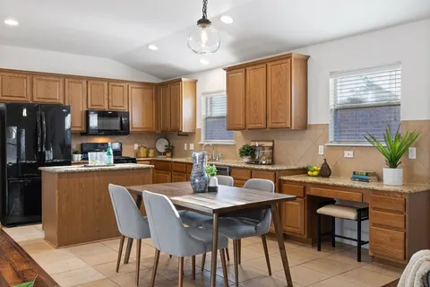 a living room with furniture kitchen view and a potted plant