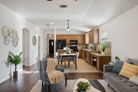 a living room with furniture and wooden floor