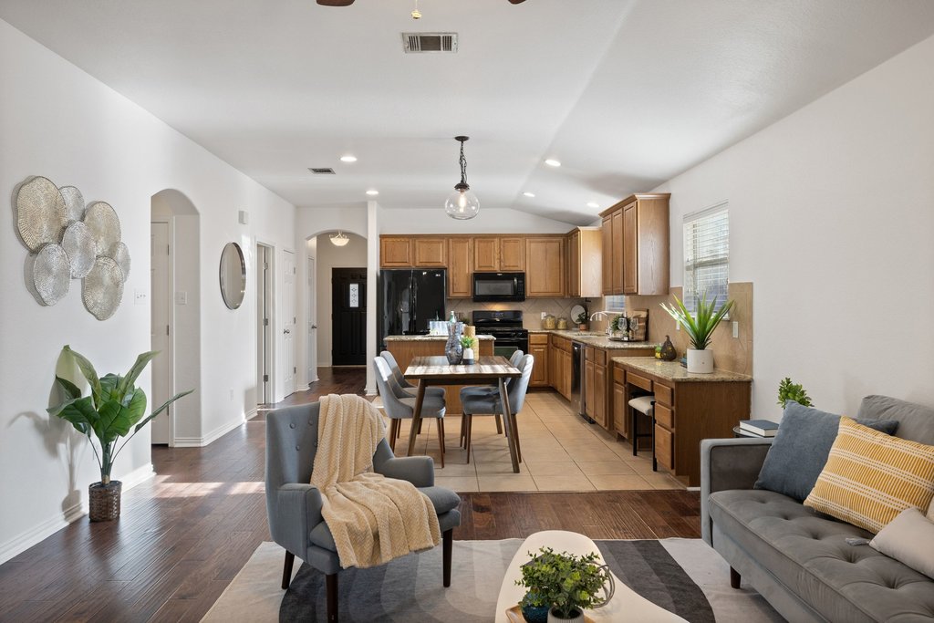 218 Calline Mayes Run Buda, TX 78610 - Photo 9 of 27 a living room with furniture kitchen view and a potted plant