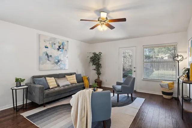 a living room with furniture kitchen view and a chandelier