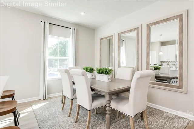 a dining room with furniture and wooden floor