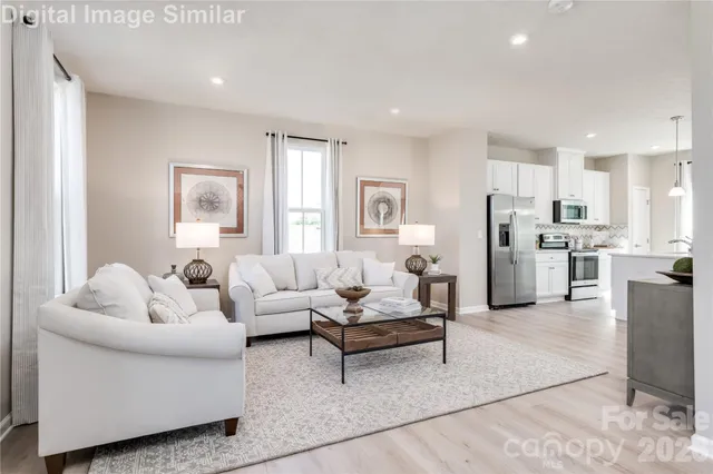 a living room with furniture and kitchen view