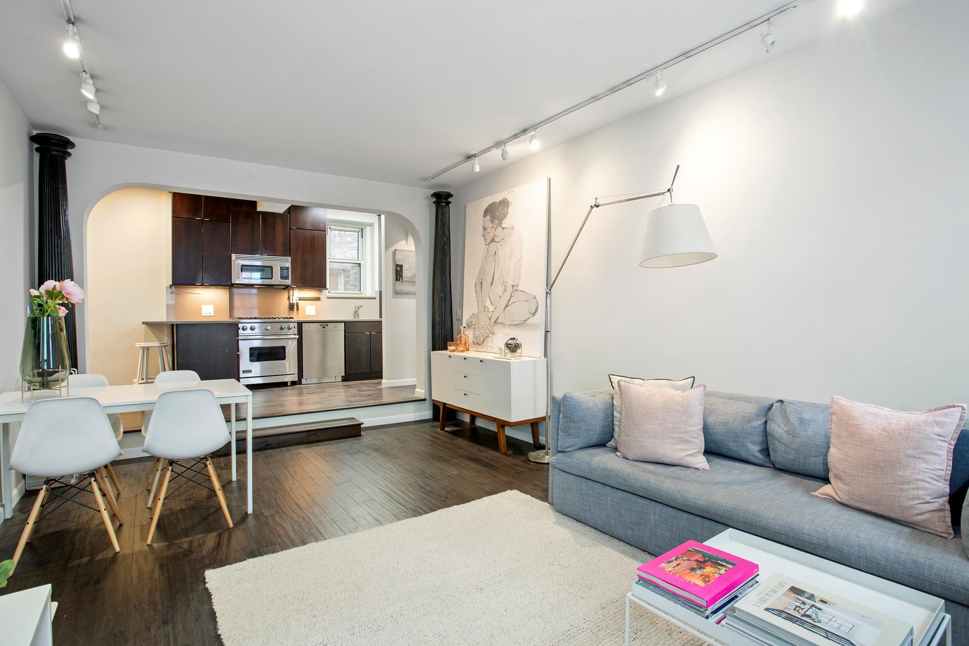 210 West 19th Street, Unit 3A Manhattan, NY 10011 - Photo 3 of 7 a living room with furniture and a dining table with kitchen view