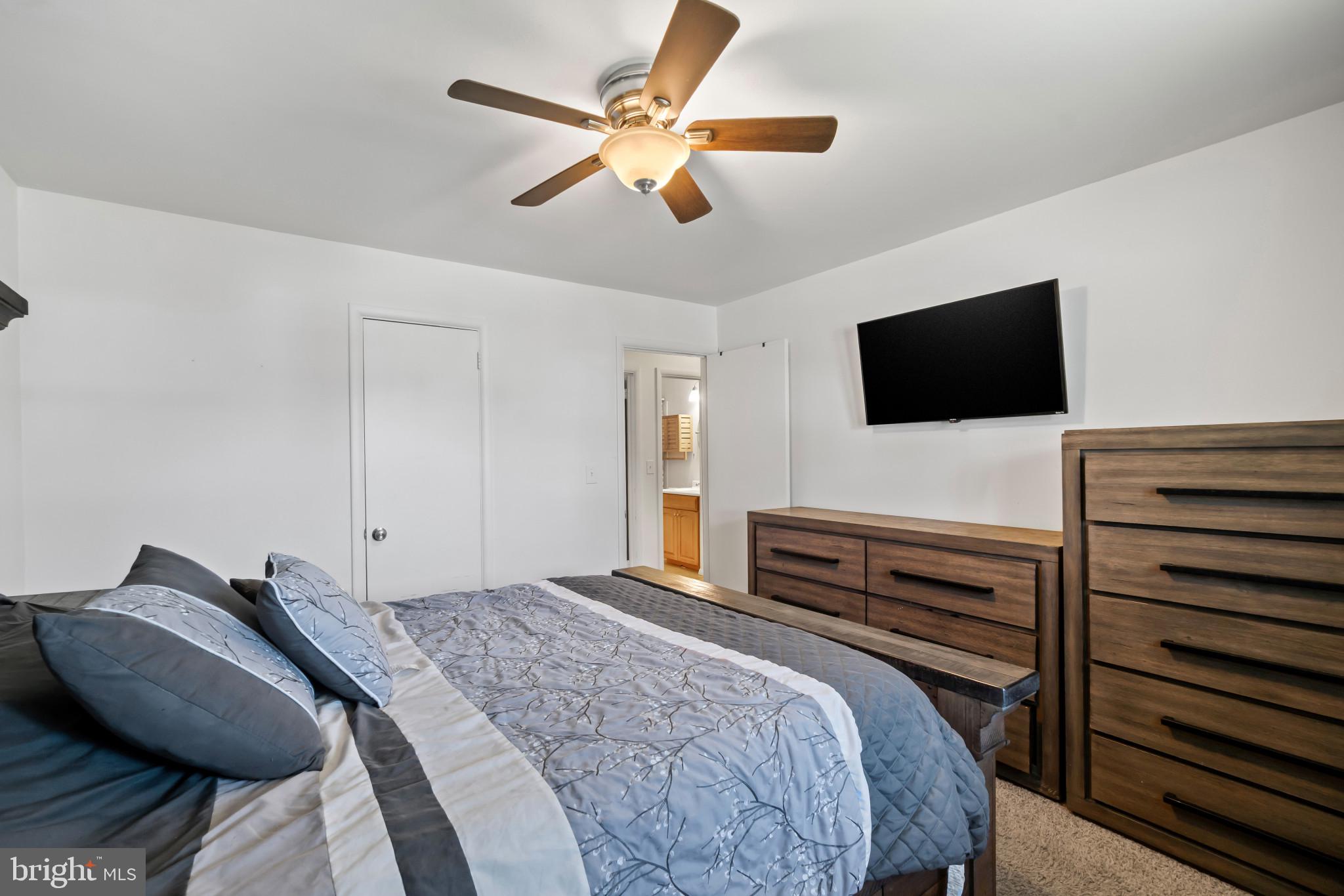 415 Baylor Road Glen Burnie, MD 21061 - Photo 12 of 29 a bedroom with a bed and a flat screen tv