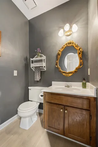 a bathroom with a toilet a sink and a mirror