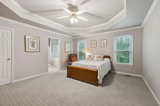 a spacious bedroom with a bed and a window