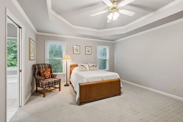 a bedroom with a bed and ceiling fan