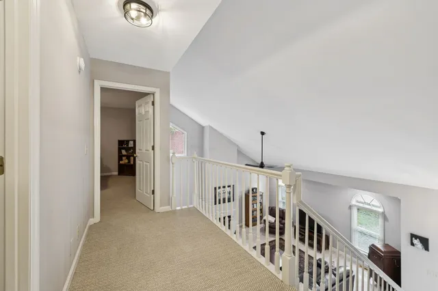 a view of a hallway and a livingroom with wooden floor