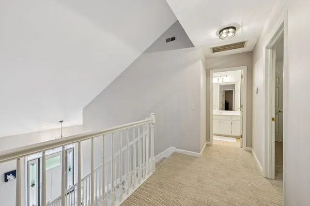 a bedroom with a bed and a lamp on the dresser