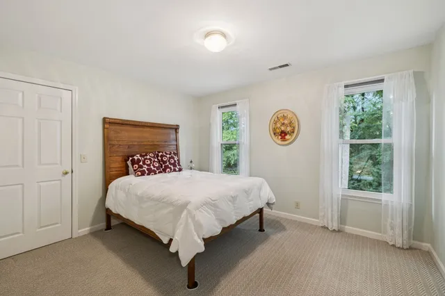 a bathroom with a granite countertop sink a toilet and a mirror
