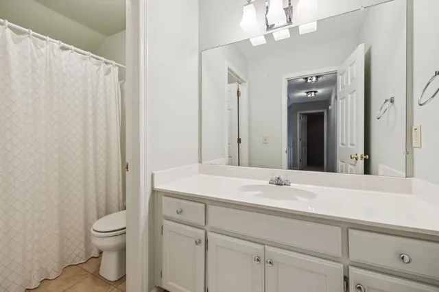 a spacious bedroom with a bed and a large window