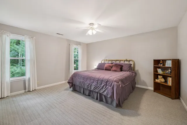 a bedroom with a large bed and a chandelier
