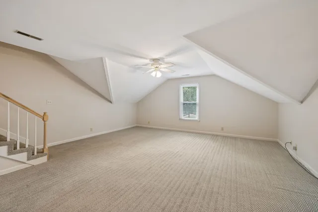 an empty room with a empty space and a ceiling fan