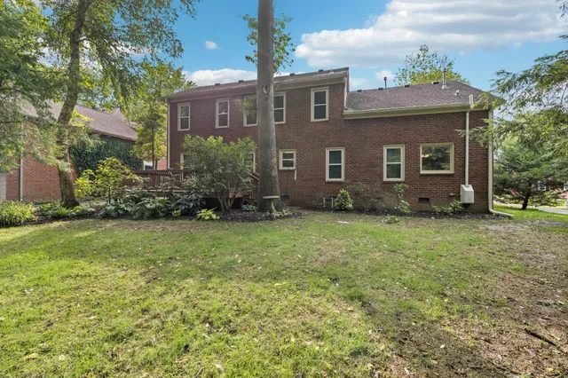 a view of a house with garden and yard