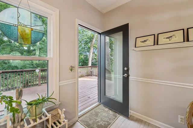 a view of a house with a wooden deck