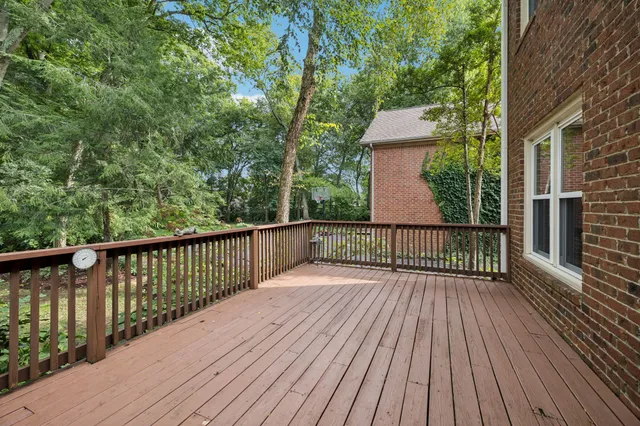 a balcony with wooden floor and fence