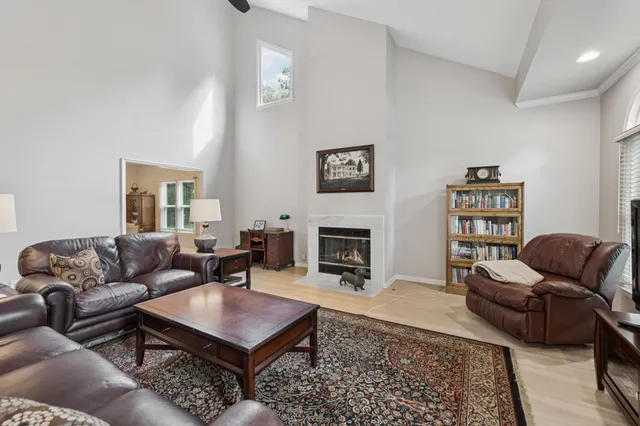 a living room with furniture a rug and a fireplace