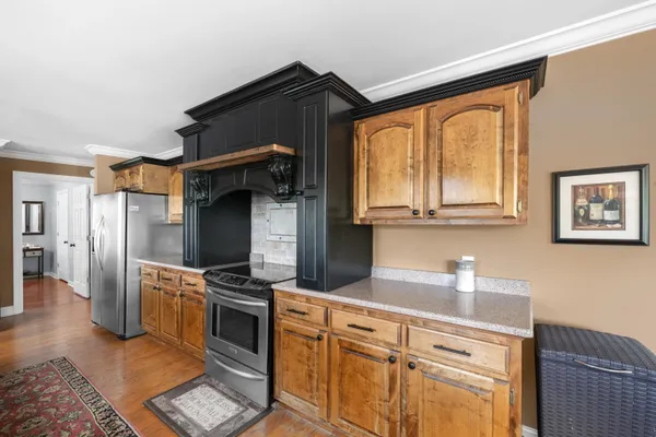 a kitchen with stainless steel appliances a stove sink and refrigerator