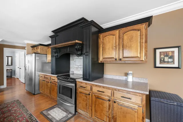 a kitchen with stainless steel appliances a stove sink and refrigerator