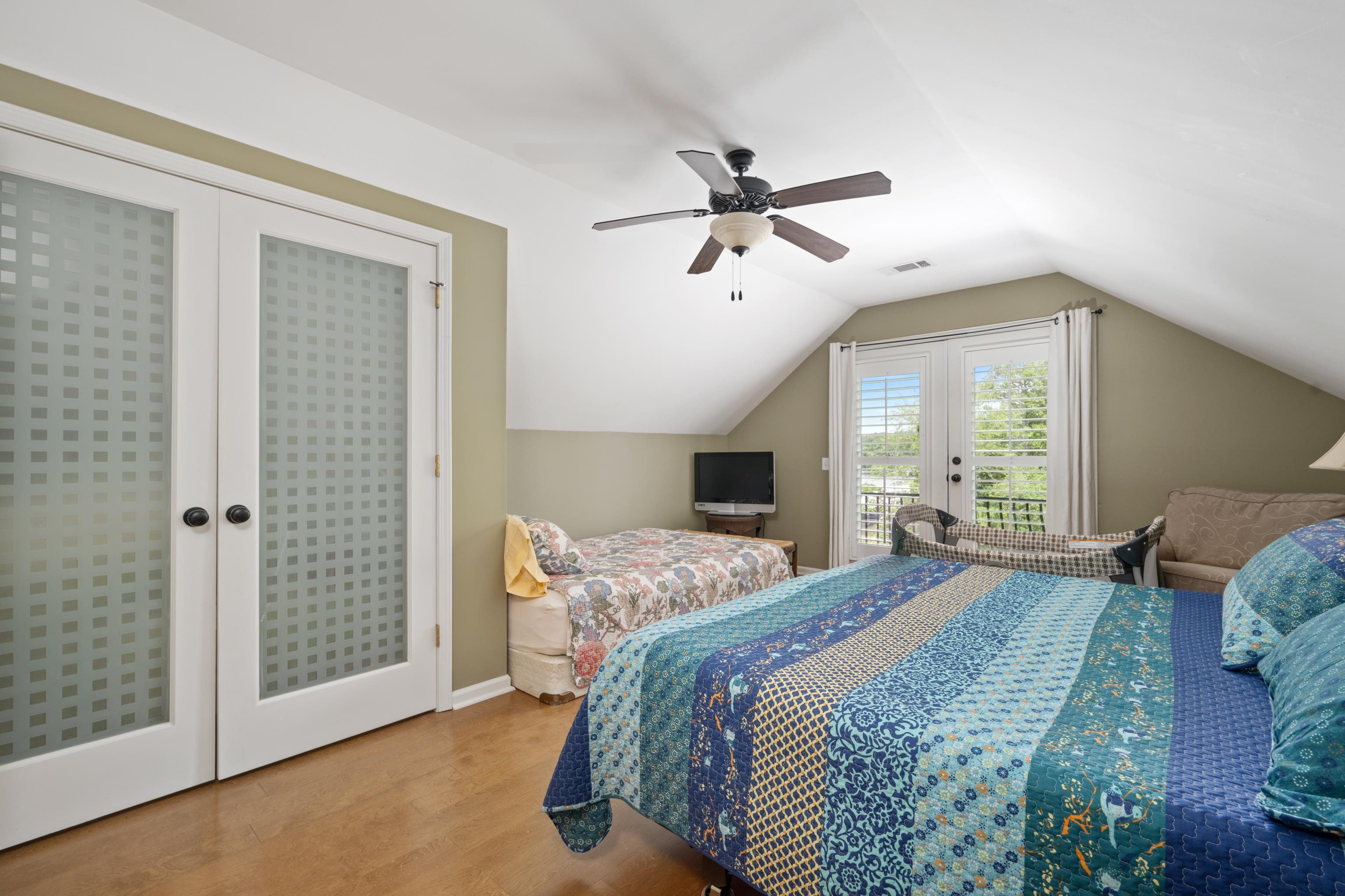 685 River Cliff Lane Counce, TN 38326 - Photo 15 of 39 a bedroom with a bed a window and a chandelier