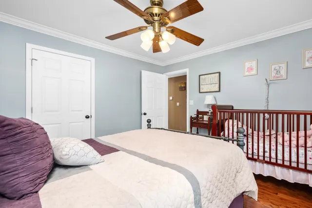 a bedroom with a bed and a chandelier