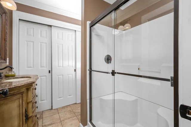 a bathroom with a shower and a sink