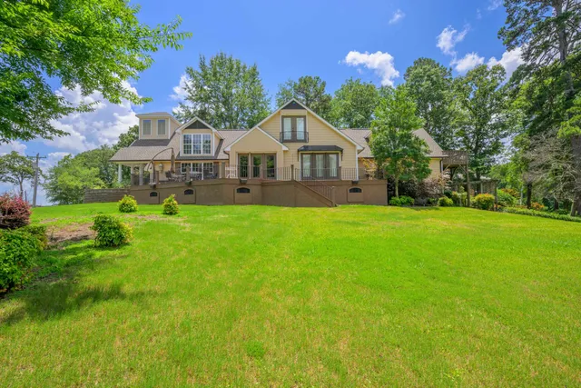 a front view of a house with yard and green space