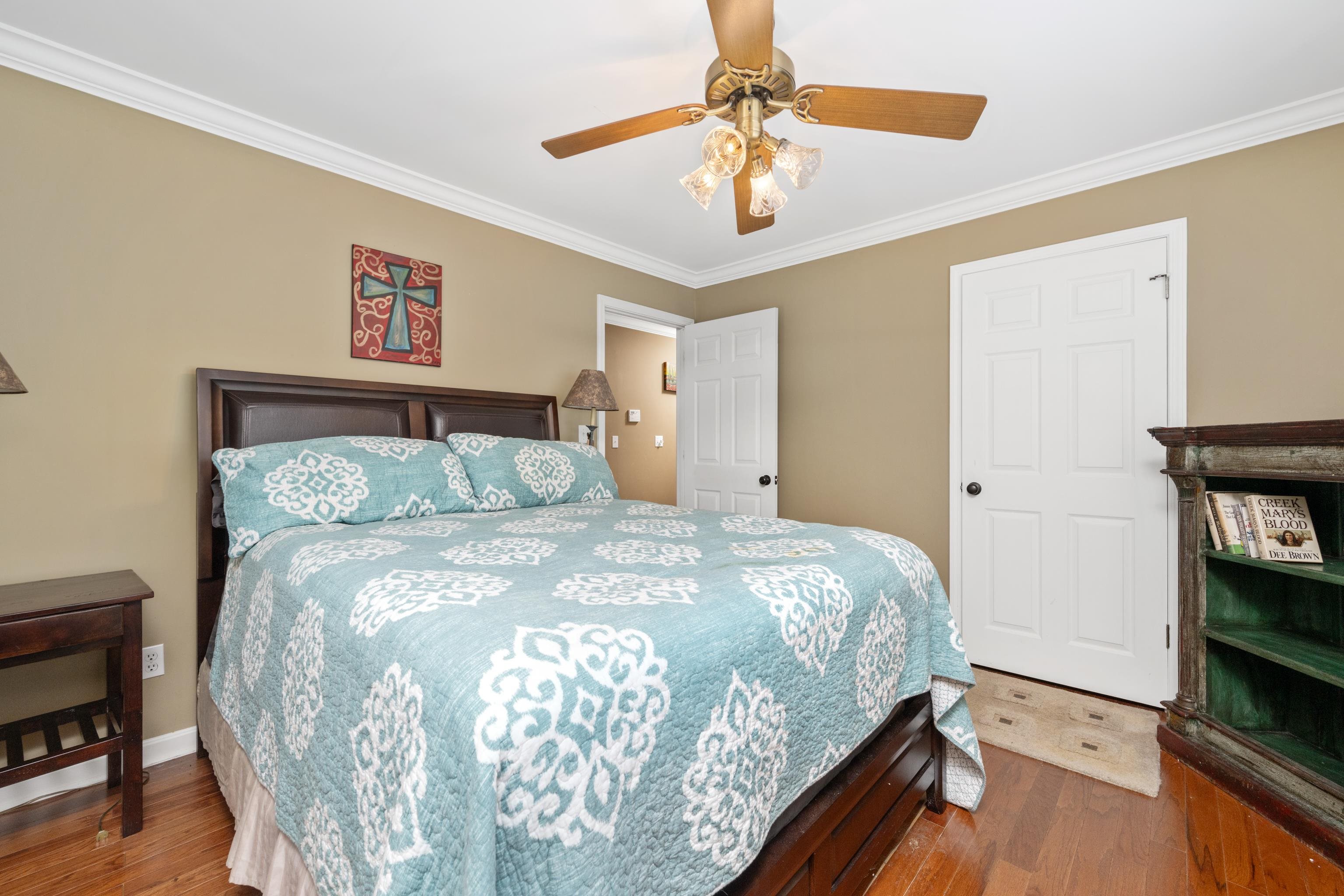 685 River Cliff Lane Counce, TN 38326 - Photo 22 of 39 a bedroom with a bed and a chandelier